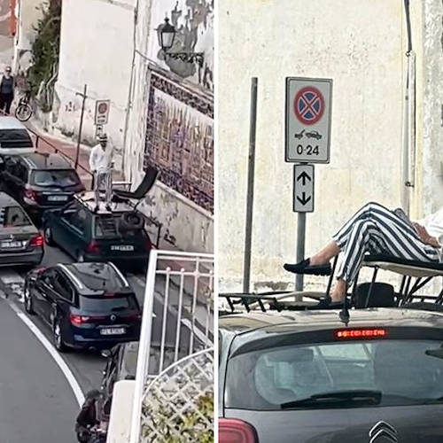 Singolare episodio ad Amalfi, turista accosta e si accomoda sul tettuccio dell’auto / VIDEO 